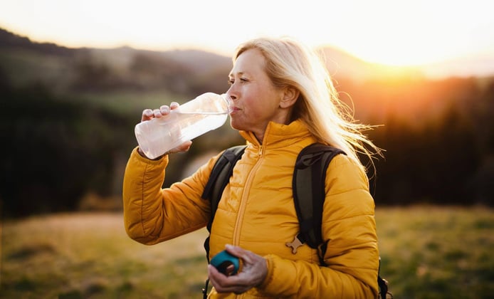 Attractive senior woman walking outdoors in nature