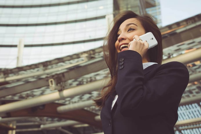 Business woman making a phone call outside the off