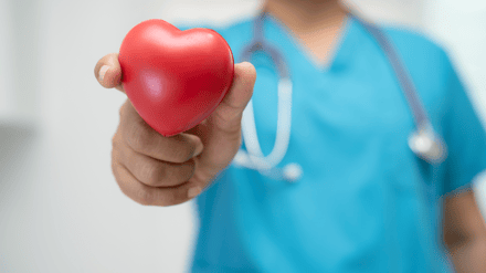 medical professional holding a red heart