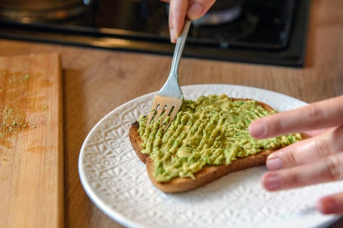 Close up photo of person using fork to spread mash