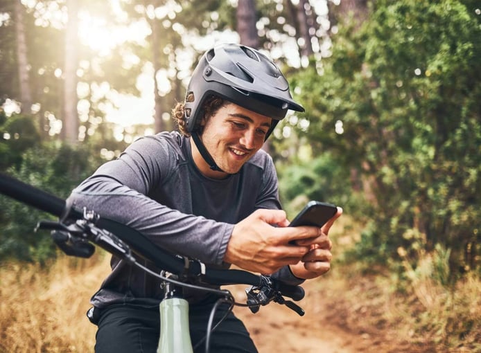 Cycling man in forest phone gps and map direction