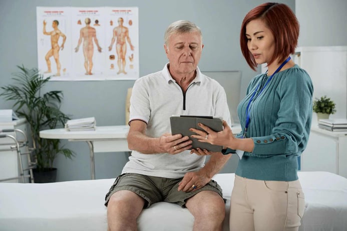 Physiotherapist talking to senior patient