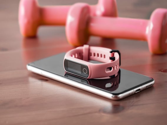 a phone with a smart watch and dumbbells