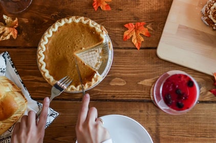 Pie being cut on an autumnal table