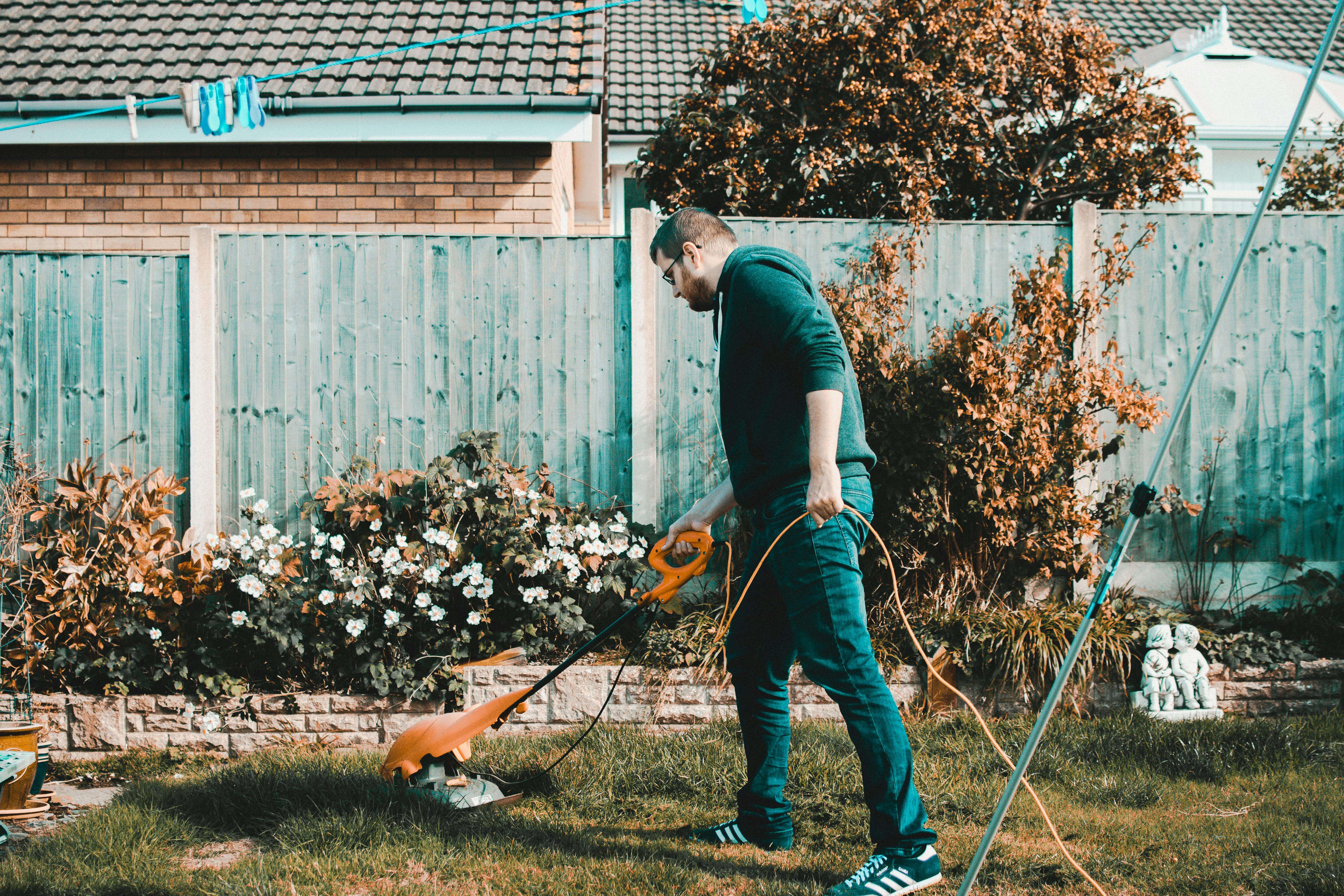 A man with a mower gardening